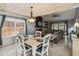 Dining area featuring wood plank ceiling, brick fireplace, and large windows at 9939 Triple Crown Cir, Orlando, FL 32825