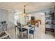 Open dining area with wood plank ceilings and views of the kitchen and living room at 9939 Triple Crown Cir, Orlando, FL 32825