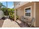 Patio outside front door with chairs, table, and brick pavers at 9939 Triple Crown Cir, Orlando, FL 32825