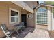 Front entrance featuring a cozy patio area with chairs, and brick pavers at 9939 Triple Crown Cir, Orlando, FL 32825