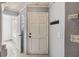 Bright foyer featuring coat rack, tile flooring, and glass block window at 9939 Triple Crown Cir, Orlando, FL 32825