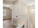 Hallway with white banister leading to the bedroom featuring modern ceiling fan and plenty of natural light at 9939 Triple Crown Cir, Orlando, FL 32825