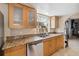 Well-lit kitchen with stainless steel appliances and a window overlooking the backyard at 9939 Triple Crown Cir, Orlando, FL 32825