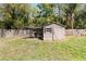 Backyard with a charming shed and covered area, great for storage or workshop space at 9939 Triple Crown Cir, Orlando, FL 32825