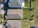 Aerial view of a home showcasing its roof, landscaping, and surrounding neighborhood, highlighting the property's location at 10018 Halesia Woods Dr, Orlando, FL 32832