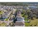 Gorgeous aerial view showcasing the home's location in a well-planned community with mature trees and a nearby lake at 10018 Halesia Woods Dr, Orlando, FL 32832