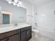 This bathroom features a single sink vanity with modern fixtures and a shower/tub combo with white subway tile at 10018 Halesia Woods Dr, Orlando, FL 32832