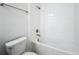 Bright bathroom featuring a shower-over-tub with white tiles and bronze fixtures at 10018 Halesia Woods Dr, Orlando, FL 32832