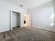 Cozy bedroom featuring neutral carpeting, closet, and access to the bathroom at 10018 Halesia Woods Dr, Orlando, FL 32832