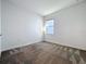 Cozy bedroom featuring plush carpet and natural light from the window at 10018 Halesia Woods Dr, Orlando, FL 32832
