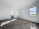 Bright bedroom featuring carpet, neutral walls, and windows that provide plenty of natural light at 10018 Halesia Woods Dr, Orlando, FL 32832