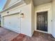 Close-up of exterior featuring brick driveway, garage door, and front door with stylish lighting at 10018 Halesia Woods Dr, Orlando, FL 32832