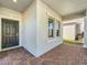 View of the brick-paved front entrance and well-lit covered porch at 10018 Halesia Woods Dr, Orlando, FL 32832