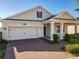Charming single-Gathering home features a two-car garage and covered front porch at 10018 Halesia Woods Dr, Orlando, FL 32832