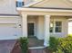 Inviting front porch with brick flooring, white columns, and manicured shrubs enhancing curb appeal at 10018 Halesia Woods Dr, Orlando, FL 32832