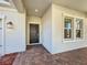 Covered front porch and dark-colored front door with transom window at 10018 Halesia Woods Dr, Orlando, FL 32832