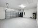 Clean and spacious two-car garage with ample storage, featuring an automatic door and utility connections at 10018 Halesia Woods Dr, Orlando, FL 32832