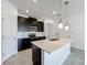 Modern kitchen features a large center island and stainless steel appliances at 10018 Halesia Woods Dr, Orlando, FL 32832