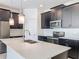 New kitchen boasts a center island, stainless appliances, and sleek dark cabinetry at 10018 Halesia Woods Dr, Orlando, FL 32832