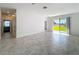 Bright and airy living room featuring tile flooring, and glass doors with a view of green space at 10018 Halesia Woods Dr, Orlando, FL 32832