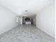 Spacious living room area flows into the kitchen with modern tile flooring at 10018 Halesia Woods Dr, Orlando, FL 32832