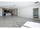 Expansive living room with tile flooring leading to kitchen and hallway with neutral paint throughout at 10018 Halesia Woods Dr, Orlando, FL 32832