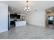 Open-concept living area flows seamlessly into a modern kitchen with stylish island and lighting at 10018 Halesia Woods Dr, Orlando, FL 32832