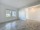 Bright living room with tiled floors and large windows, creating an inviting space at 10018 Halesia Woods Dr, Orlando, FL 32832