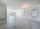 Spacious living room with tile flooring and sliding glass doors to the backyard at 10018 Halesia Woods Dr, Orlando, FL 32832