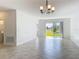 Bright and spacious living room with tile flooring and sliding glass doors leading to outdoor space at 10018 Halesia Woods Dr, Orlando, FL 32832