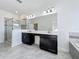 The main bathroom features a glass walk-in shower, dual sink vanity, and tiled floors at 10018 Halesia Woods Dr, Orlando, FL 32832