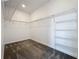 Spacious walk-in closet with metal shelving and carpet floors at 10018 Halesia Woods Dr, Orlando, FL 32832