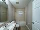 Bathroom features vanity with sink, shower-tub combo with tiled backsplash and updated faucet at 110 Evergreen Dr, Auburndale, FL 33823