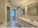 Bright bathroom featuring double sinks with square mirrors and a shower enclosure at 110 Evergreen Dr, Auburndale, FL 33823
