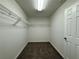 Walk-in closet with carpet, overhead light, door, and wire shelving at 110 Evergreen Dr, Auburndale, FL 33823