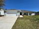 Charming single-story home featuring a two-car garage and a well-manicured front lawn at 110 Evergreen Dr, Auburndale, FL 33823