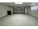 Clean and spacious garage with a gray epoxy floor and garage door at 110 Evergreen Dr, Auburndale, FL 33823