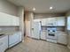 Bright kitchen showcasing white cabinets, white appliances, and tile flooring at 110 Evergreen Dr, Auburndale, FL 33823