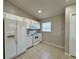 A bright kitchen with white appliances, tiled floor, and a window providing natural light at 110 Evergreen Dr, Auburndale, FL 33823