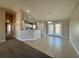 Bright kitchen featuring white cabinets, tile floors, and sliding glass doors to the backyard at 110 Evergreen Dr, Auburndale, FL 33823