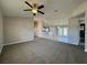 Open living space with ceiling fan flows into the kitchen with tile flooring and breakfast bar at 110 Evergreen Dr, Auburndale, FL 33823