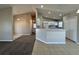 Open concept living room with tile flooring and kitchen view with breakfast bar at 110 Evergreen Dr, Auburndale, FL 33823