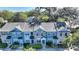 A high-angle view of the townhomes showing colorful exteriors, landscaping, parking, and overall community layout at 1178 Vineland Pl, Lake Mary, FL 32746