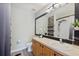 A half-bathroom with updated vanity, decorative stone detail, large mirror, and a shower-tub combination at 1178 Vineland Pl, Lake Mary, FL 32746