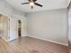 A clean, modern bedroom with new flooring, leading to en-suite bathroom with a well-lit vanity and walk-in closet at 1178 Vineland Pl, Lake Mary, FL 32746