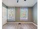 Bedroom with two windows and wood-look flooring at 1178 Vineland Pl, Lake Mary, FL 32746