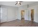 A bright bedroom with neutral tones and wood-look floors, showing multiple access doorways to adjacent rooms at 1178 Vineland Pl, Lake Mary, FL 32746