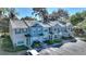 An aerial view of the townhome featuring colorful exteriors, well-maintained landscaping, and ample parking at 1178 Vineland Pl, Lake Mary, FL 32746