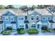 The exterior elevation of the townhome showcases colorful facades, tidy landscaping, and convenient front entrances at 1178 Vineland Pl, Lake Mary, FL 32746