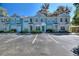 Charming townhome exterior featuring colorful facades, well-manicured landscaping, and convenient parking spaces at 1178 Vineland Pl, Lake Mary, FL 32746